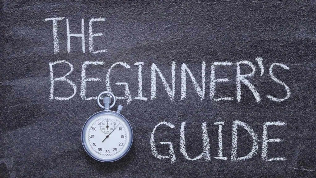 A chalkboard with the words 'The Beginner’s Guide' written in white chalk, accompanied by a classic stopwatch, symbolizing the importance of timing and preparation when starting a new journey like keto